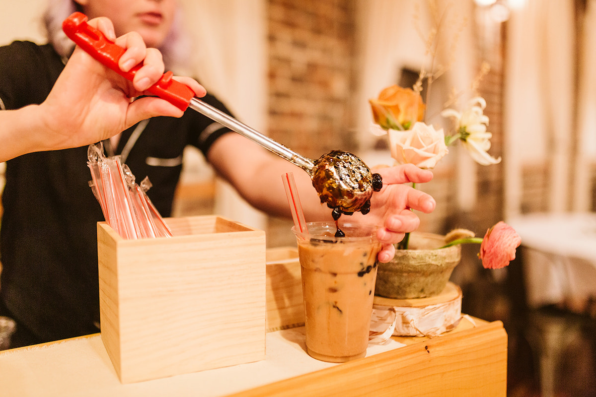 Birch Tree Boba employee scoops boba pearls into a cup of tea during a wedding reception in Cleveland, TN