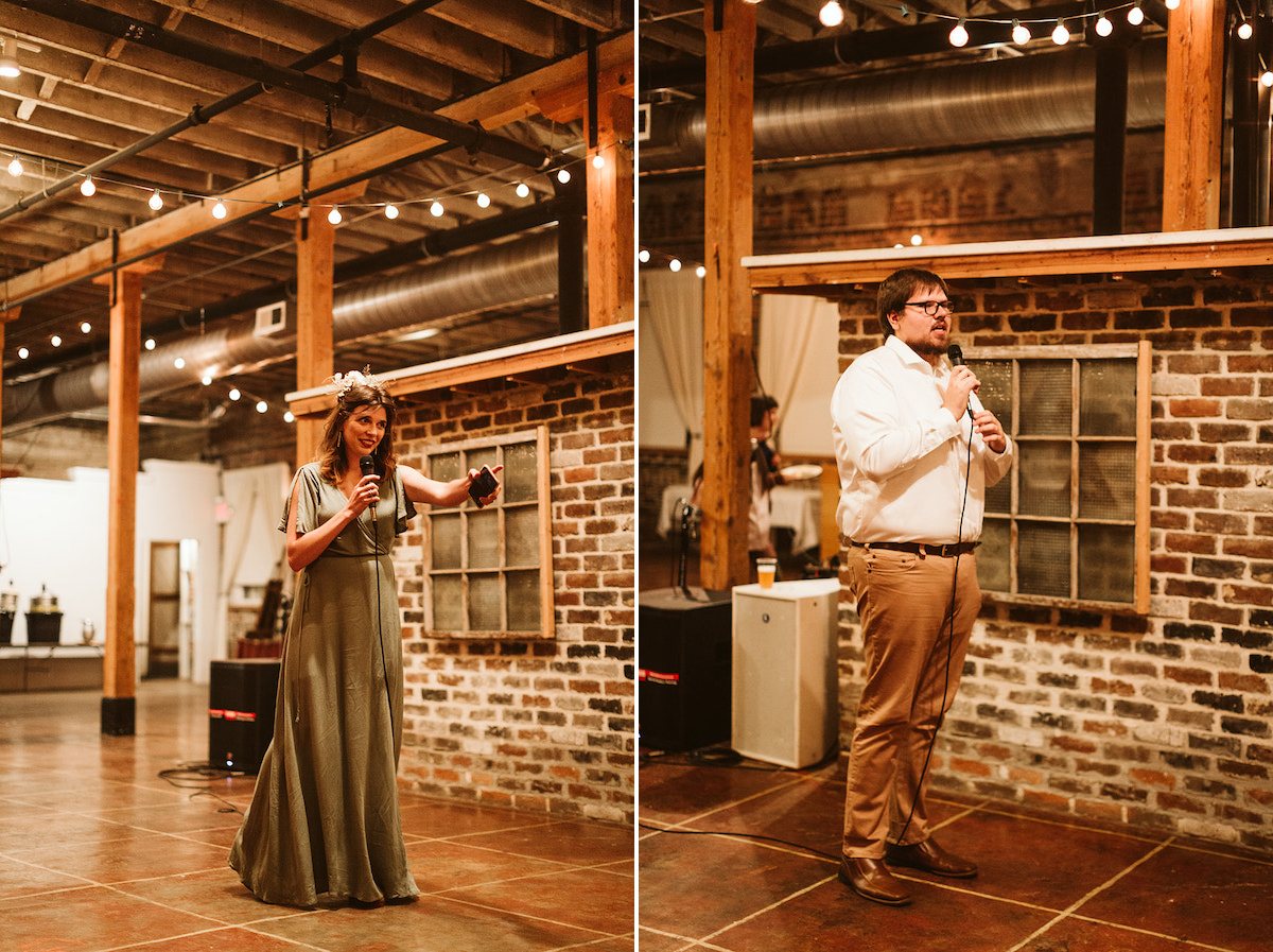 Best Man and Maid of Honor hold microphone and stand in front of exposed brick wall to deliver toasts