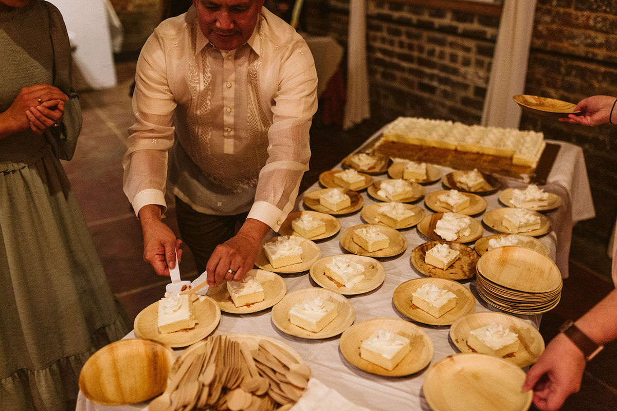 Man cuts slices of wedding sheet cake and puts them onto plates