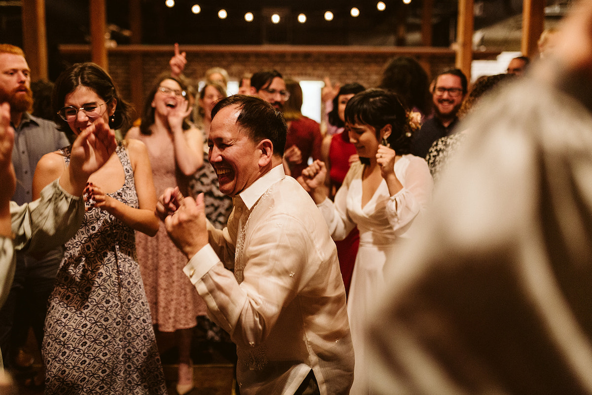 Bride and wedding guests dance during wedding reception at The Old Woolen Mill in Cleveland, TN