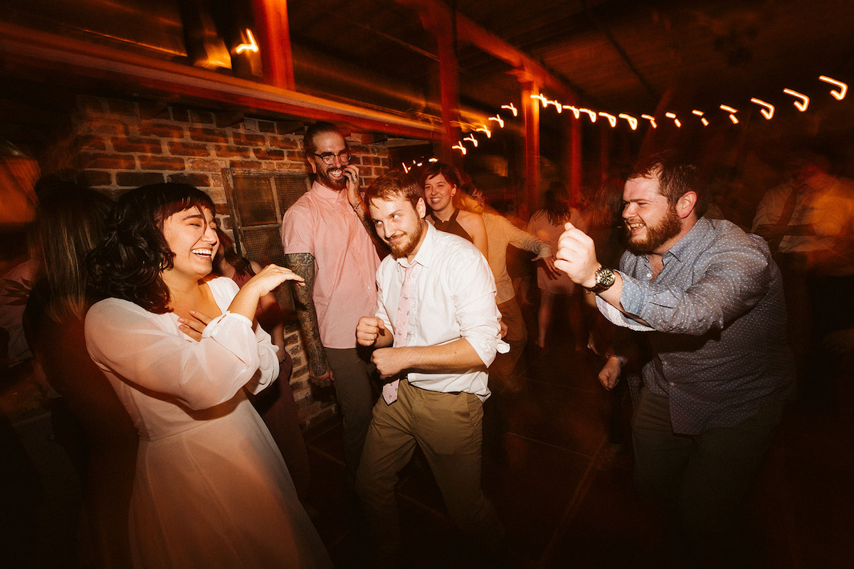 Bride and groom dance with their friends