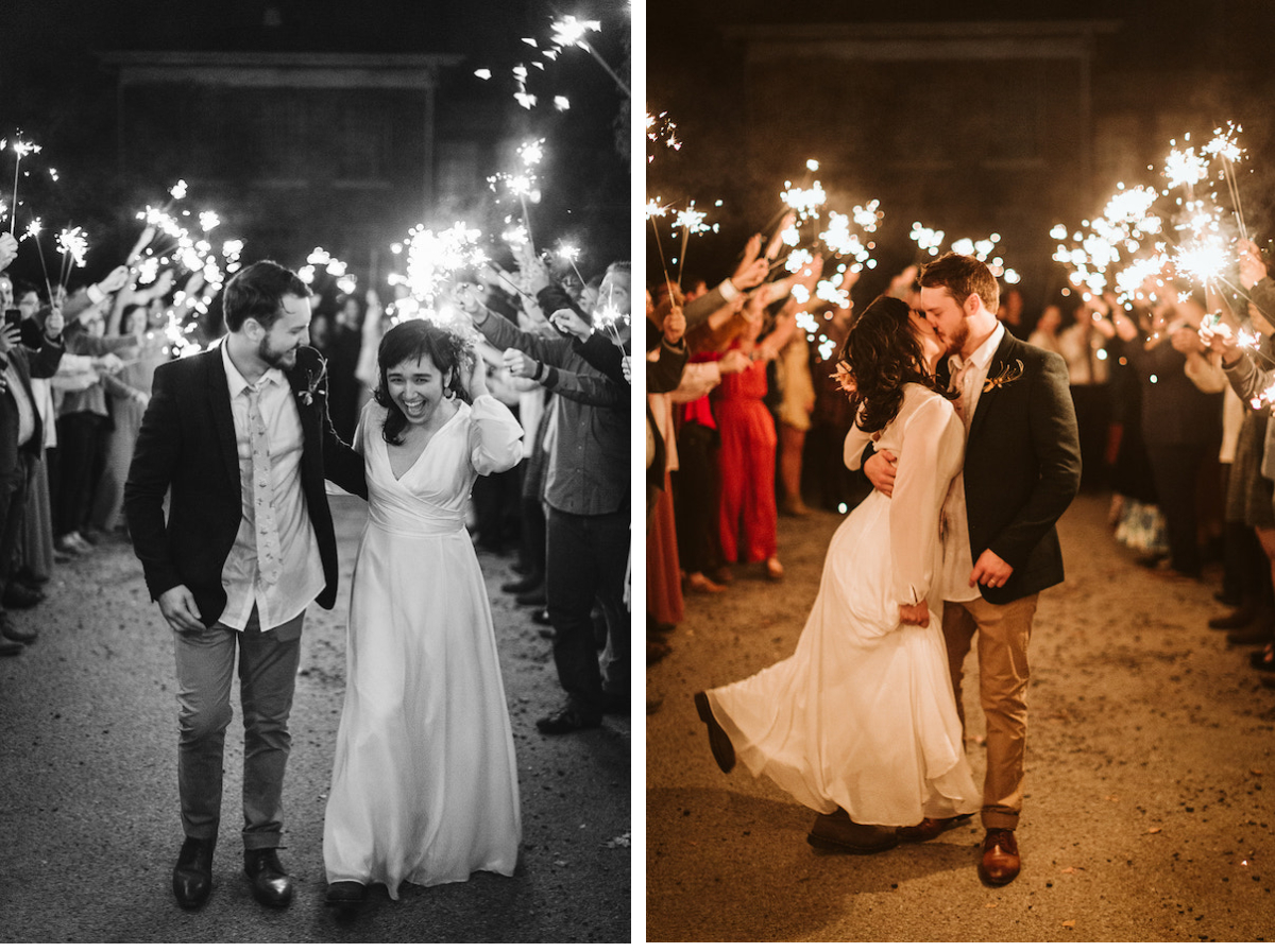 Bride and groom kiss in the middle of their sparkler exit, she kicks a foot up behind her