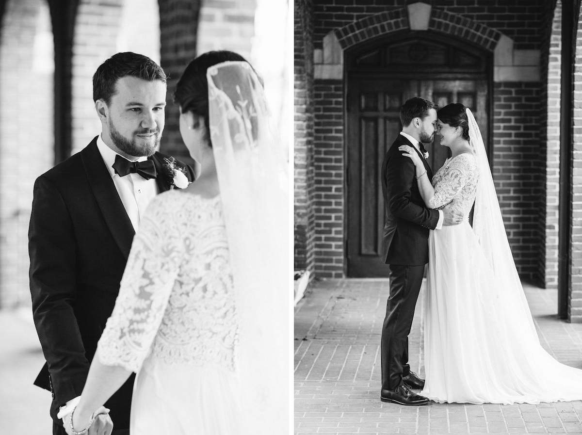 Bride and groom nuzzle under covered walkway between brick archways