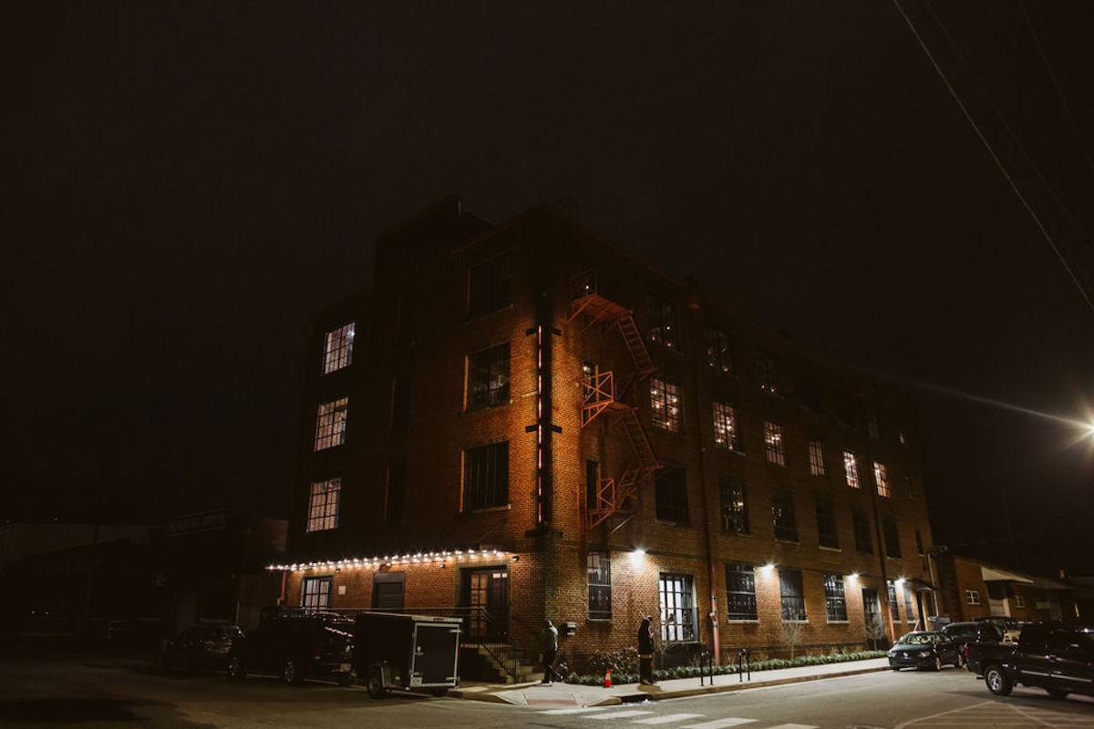 The Turnbull Building in downtown Chattanooga, TN at night, lights glowing along brick exterior