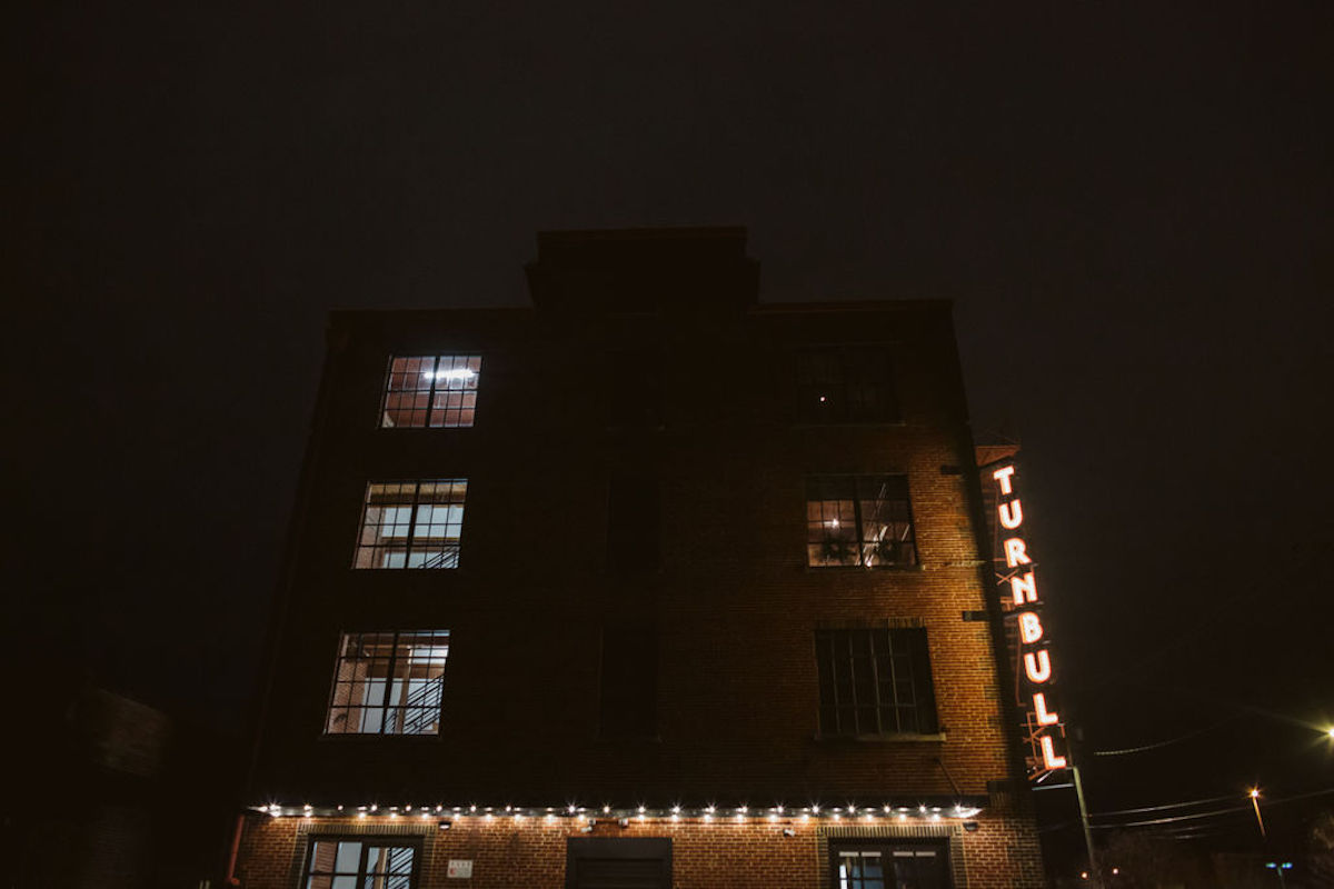 The Turnbull Building in downtown Chattanooga, TN at night, lights glowing along brick exterior