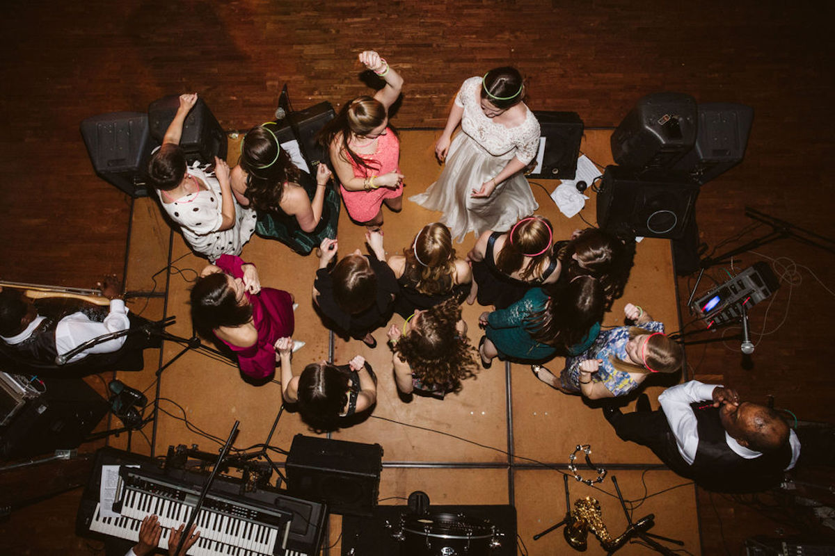 Bride and several female friends sing and dance on band's stage while the band sings and plays at The Turnbull in Chattanooga