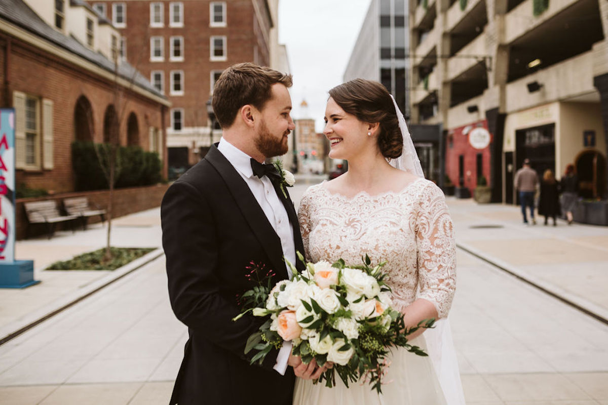 Bride and groom smile at each other in Chattanooga's West Village