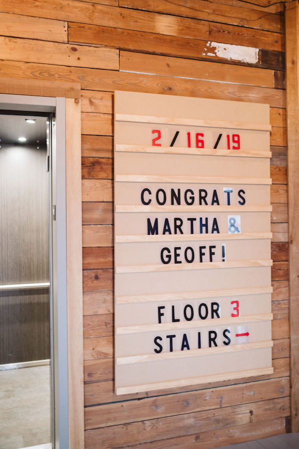 White plastic sign with changeable letters welcome bride and groom to The Turnbull Building wedding reception