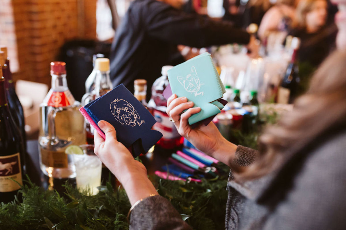 Colorful customized koozies with white sketches of pet faces and names