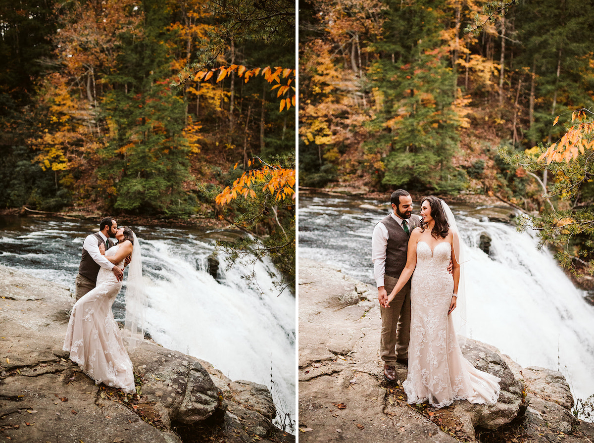 Groom and bride stand beside a rushing waterfall at autumn wedding at Fall Creek Falls State Park in Tennessee