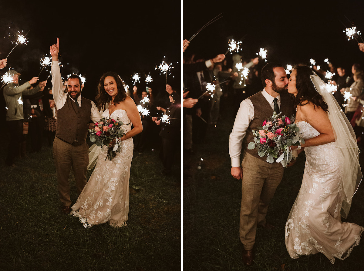 Bride and groom walk through sparkler tunnel