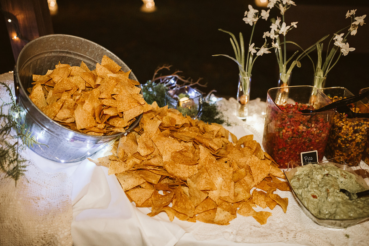 buffet chips and salsa and dips on a white tablecloth