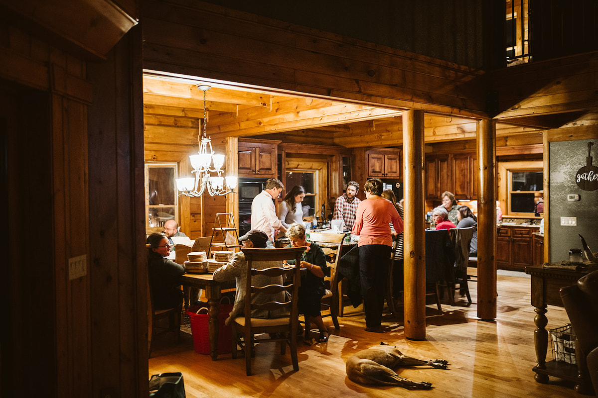 people congregate in large cabin kitchen