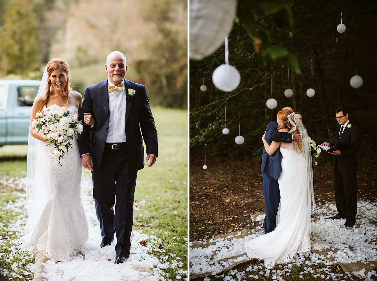 bride laughs as her father walk down a path of white flower petals through a grassy field toward wedding guests