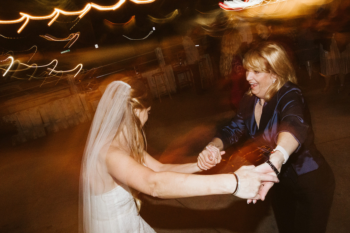 bride dances with a friend on the patio at The Daily Ration in Chattanooga, TN