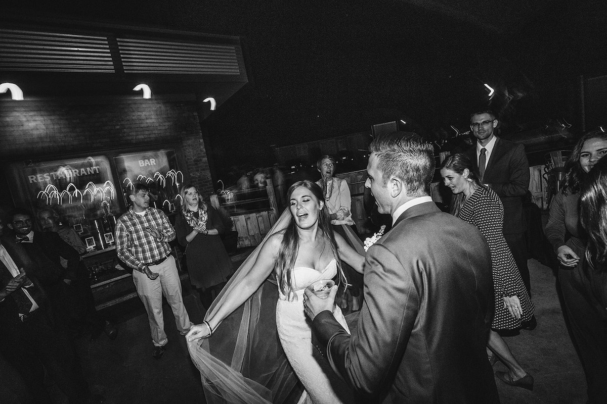 bride and groom dance with guests at their wedding reception at The Daily Ration in Chattanooga