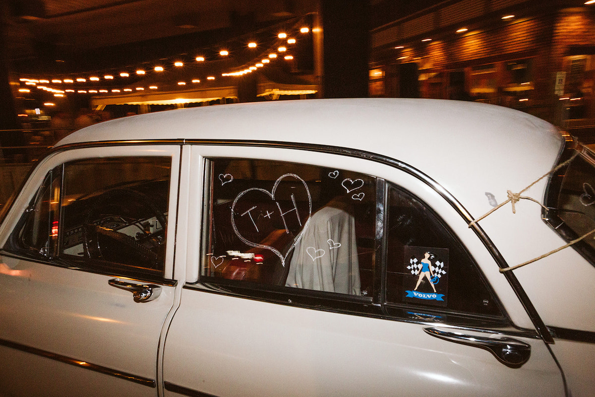 chalk "T+H" drawn on the window of a white antique car