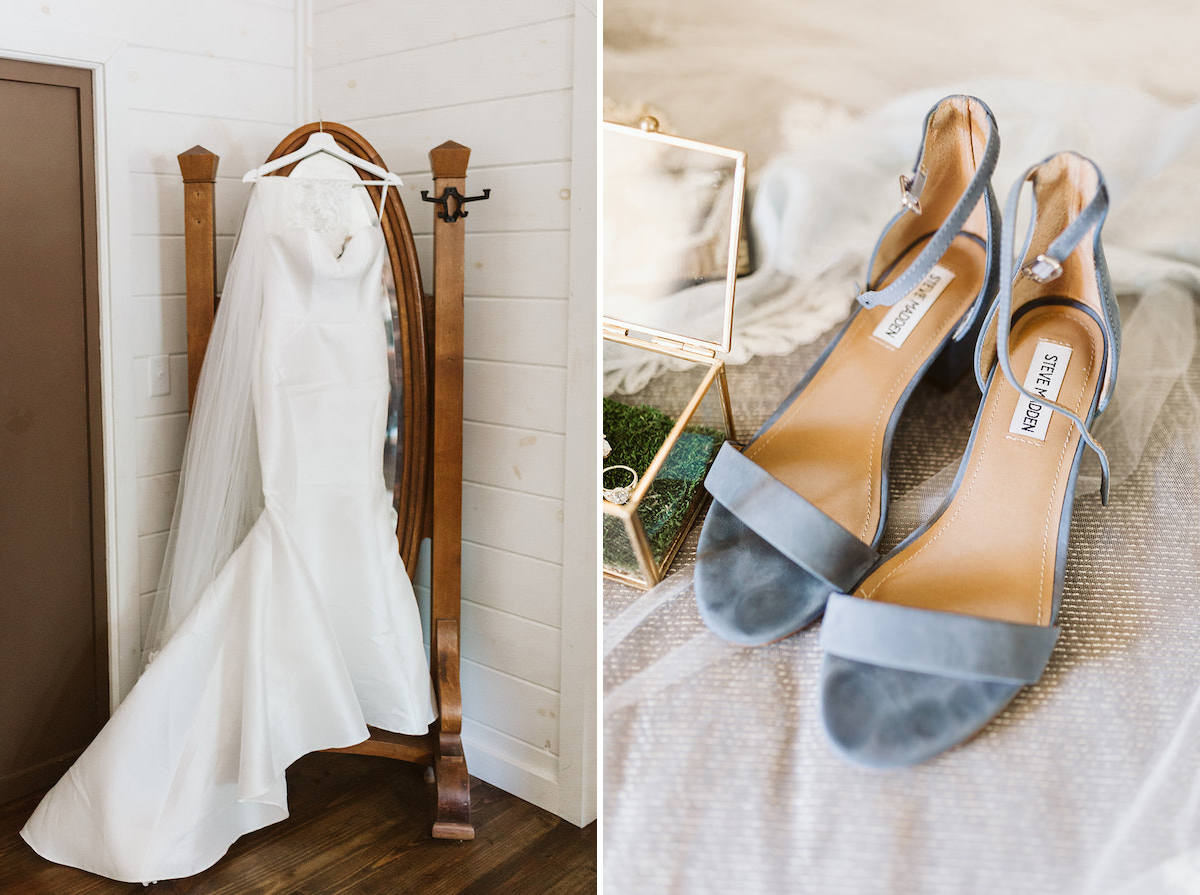 Brides strappy, blue heels rest on her veil next to a glass box containing her wedding ring