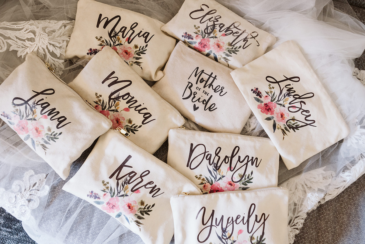 tan makeup bags painted with flowers and bridesmaid's names