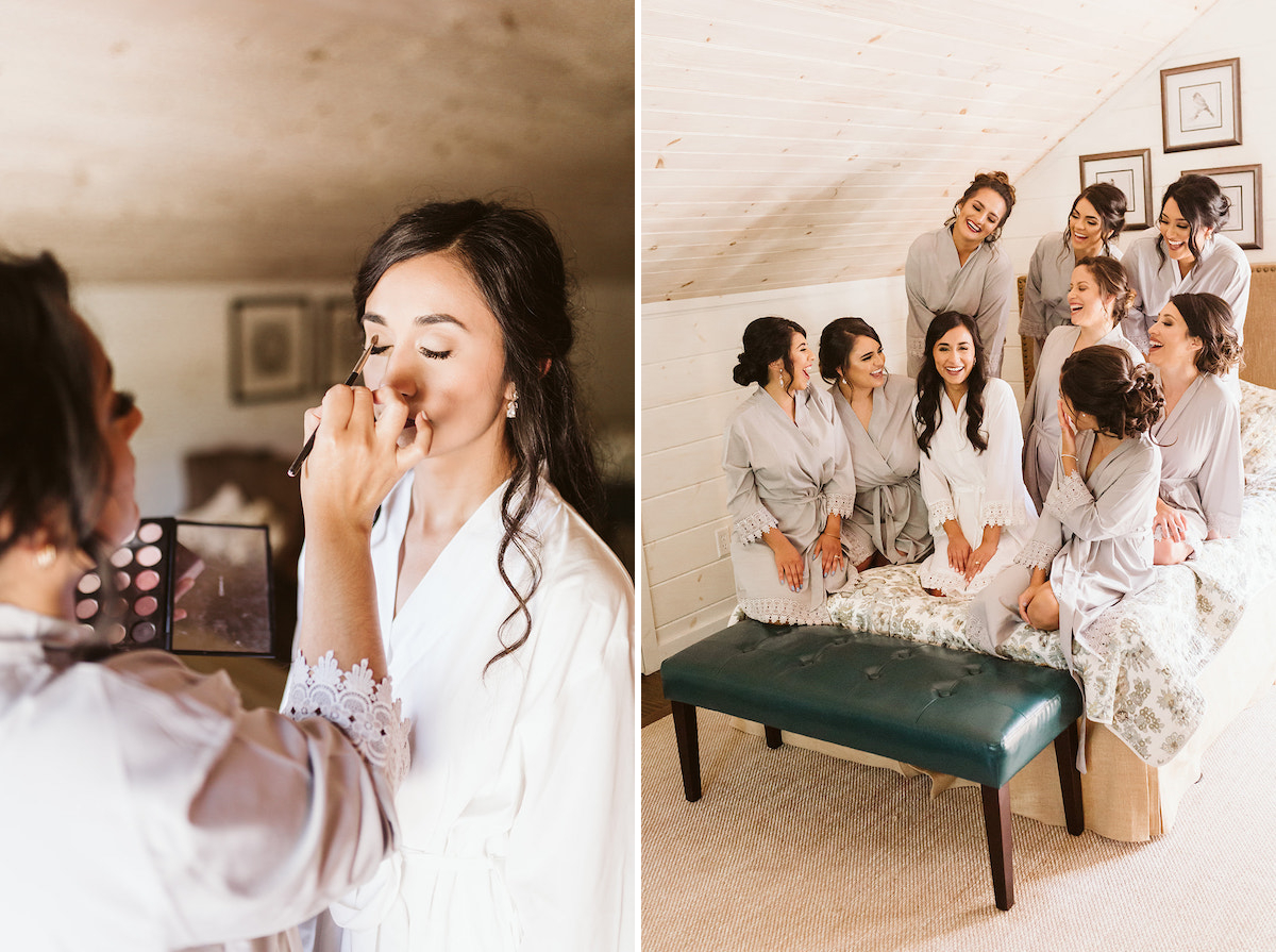 bride kneels on a bed in a white robe while bridesmaids kneels around her in gray robes