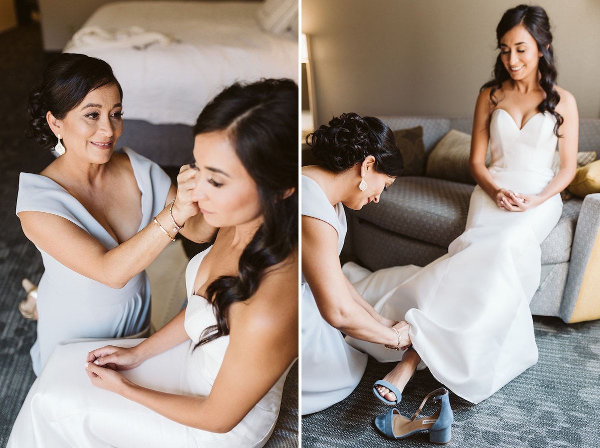 older woman straps bride's blue heels around her ankles