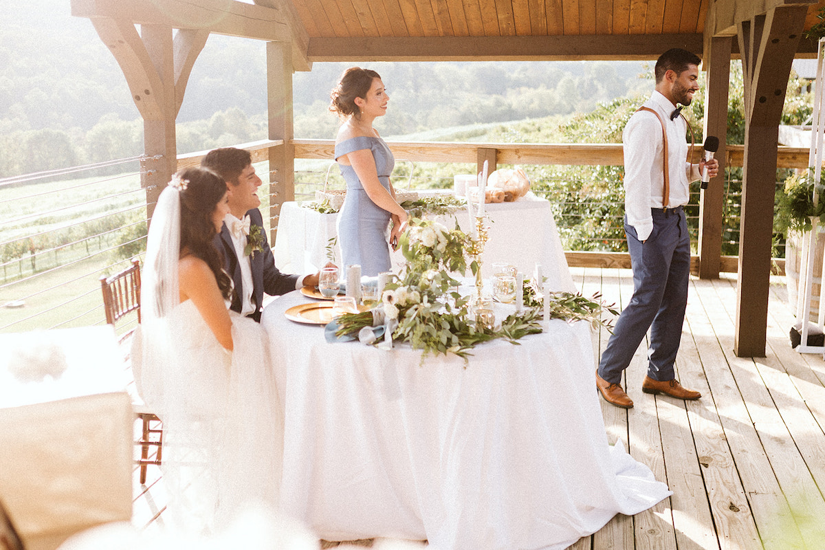 best man gives toast to the bride and groom on the porch of DeBarge Vineyard in Dalton Georgia