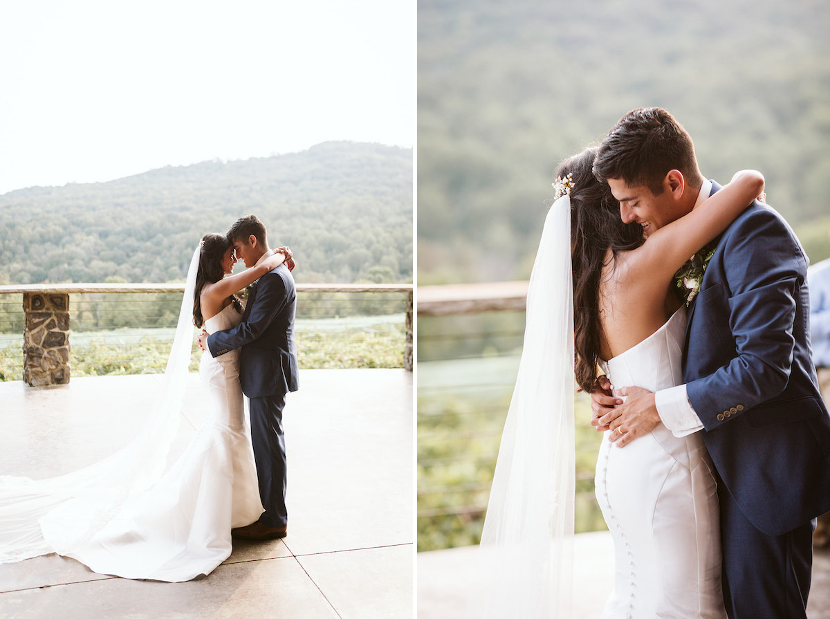 Bride and groom dance with their arms around each other with rolling hills of North Georgia in the background
