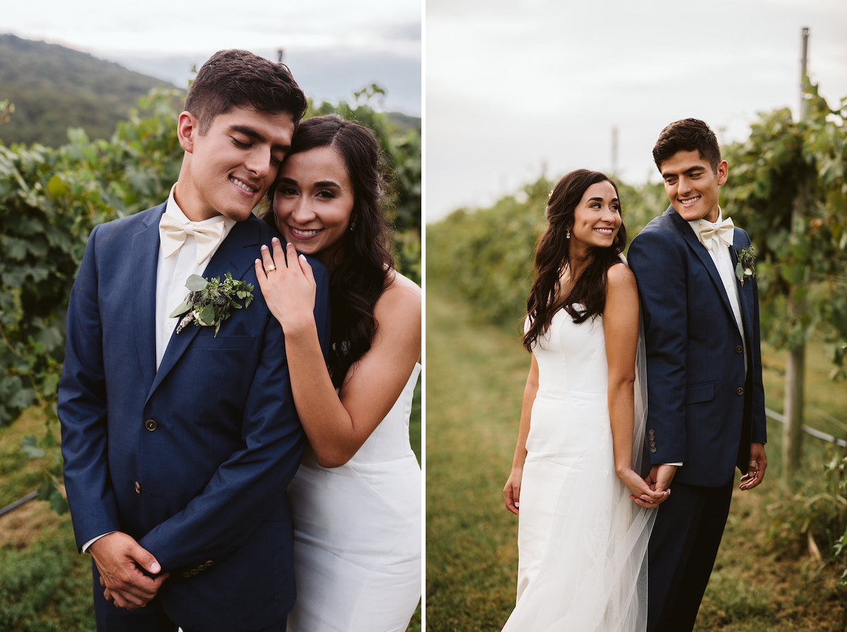 bride and groom hold hands and smile at each other next to vines of grapes at DeBarge Vineyard