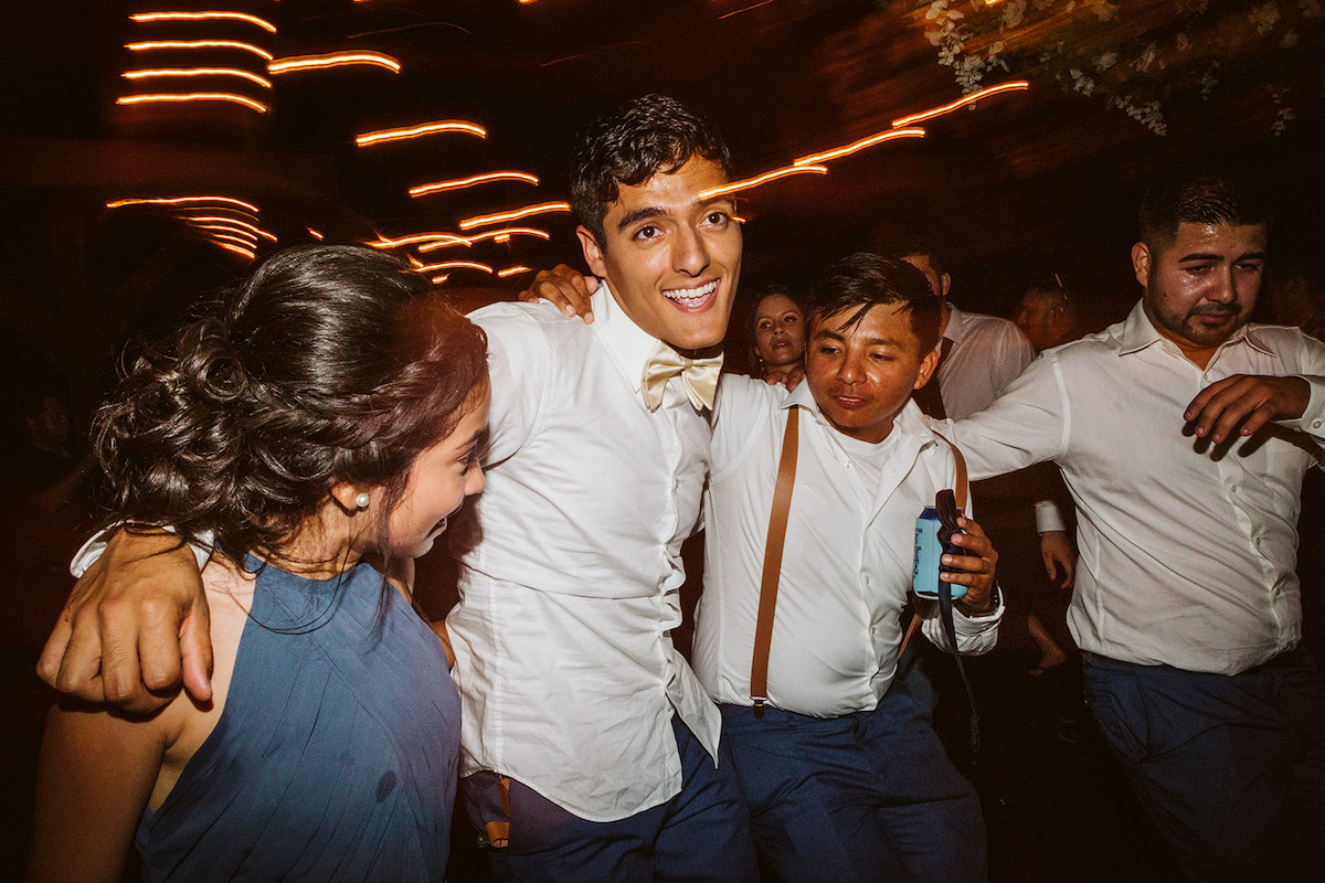 groom dances with bridesmaid and groomsmen