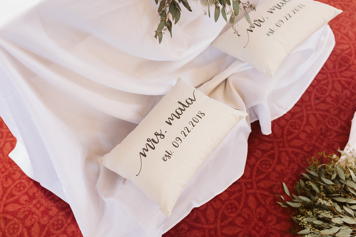 kneeling pillows at altar painted with Mr. and Mrs. and wedding date
