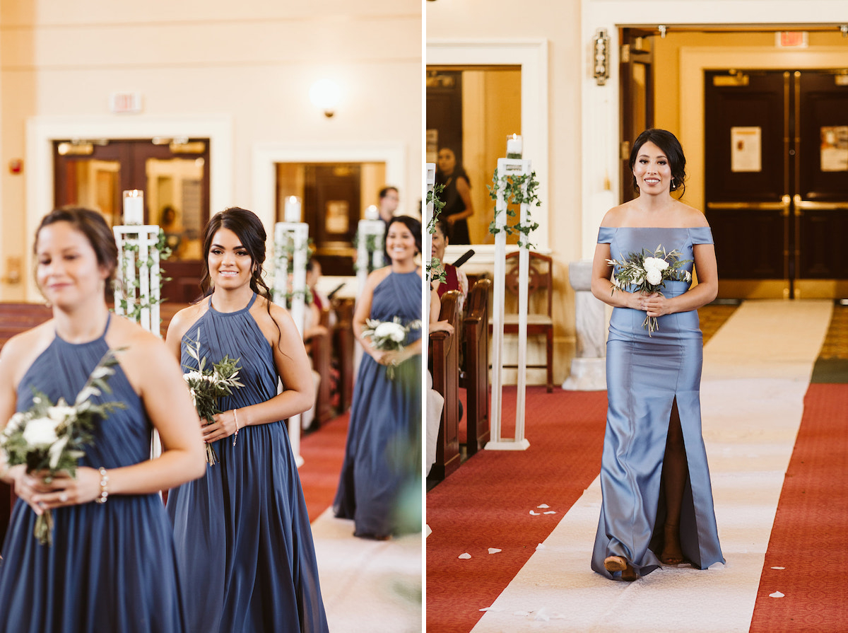 bridesmaids walk on white runner toward the altar