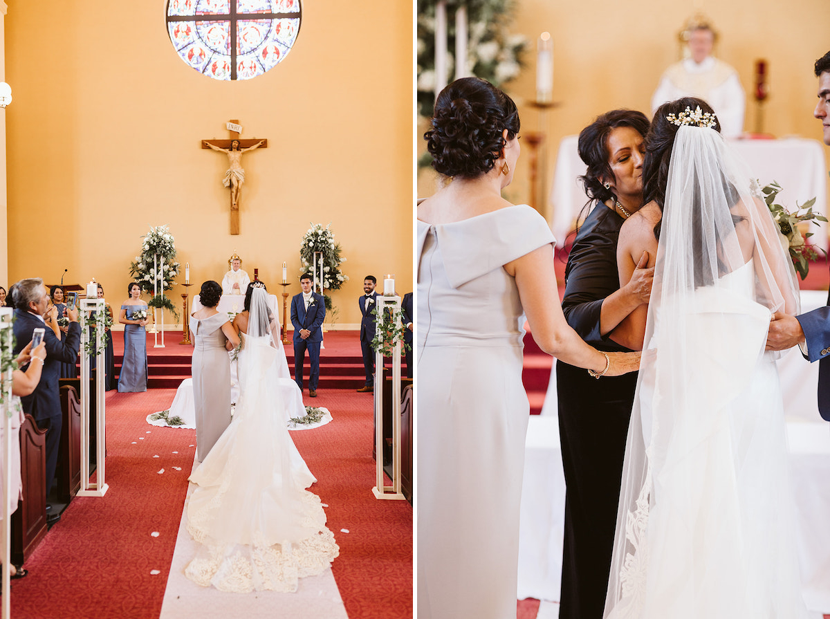 bride and her mother stand at the altar. stained glass window and crucifix above the altar