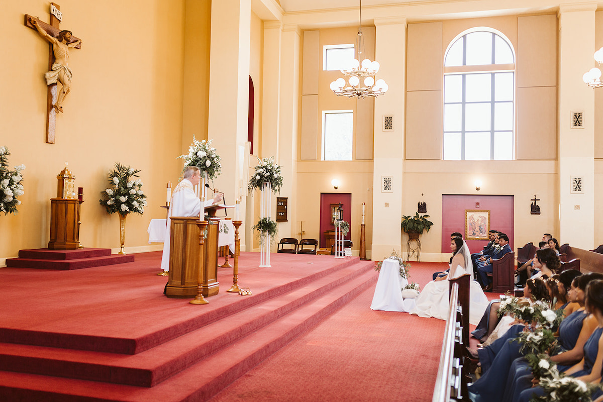 priest presents a reading at the pulpit on the wide altar at St Josephs Catholic Church in Dalton Georgia