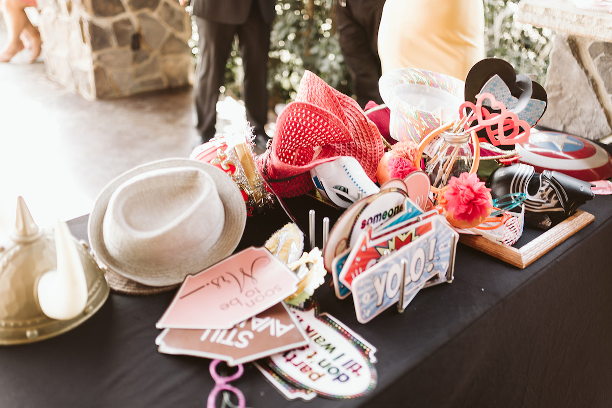 black table covered in signs, hats, and props