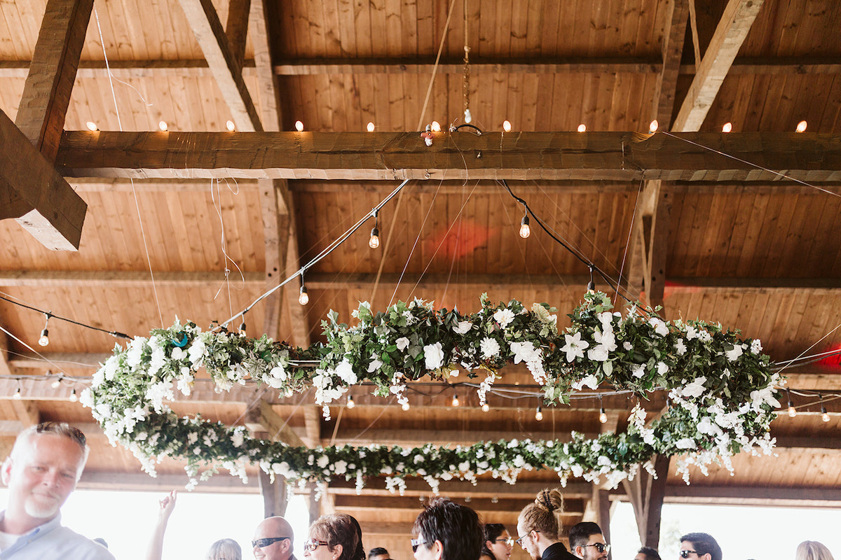 ring of greenery and white flowers hangs from exposed rough-cut rafters at DeBarge Vineyards in Dalton Georgia