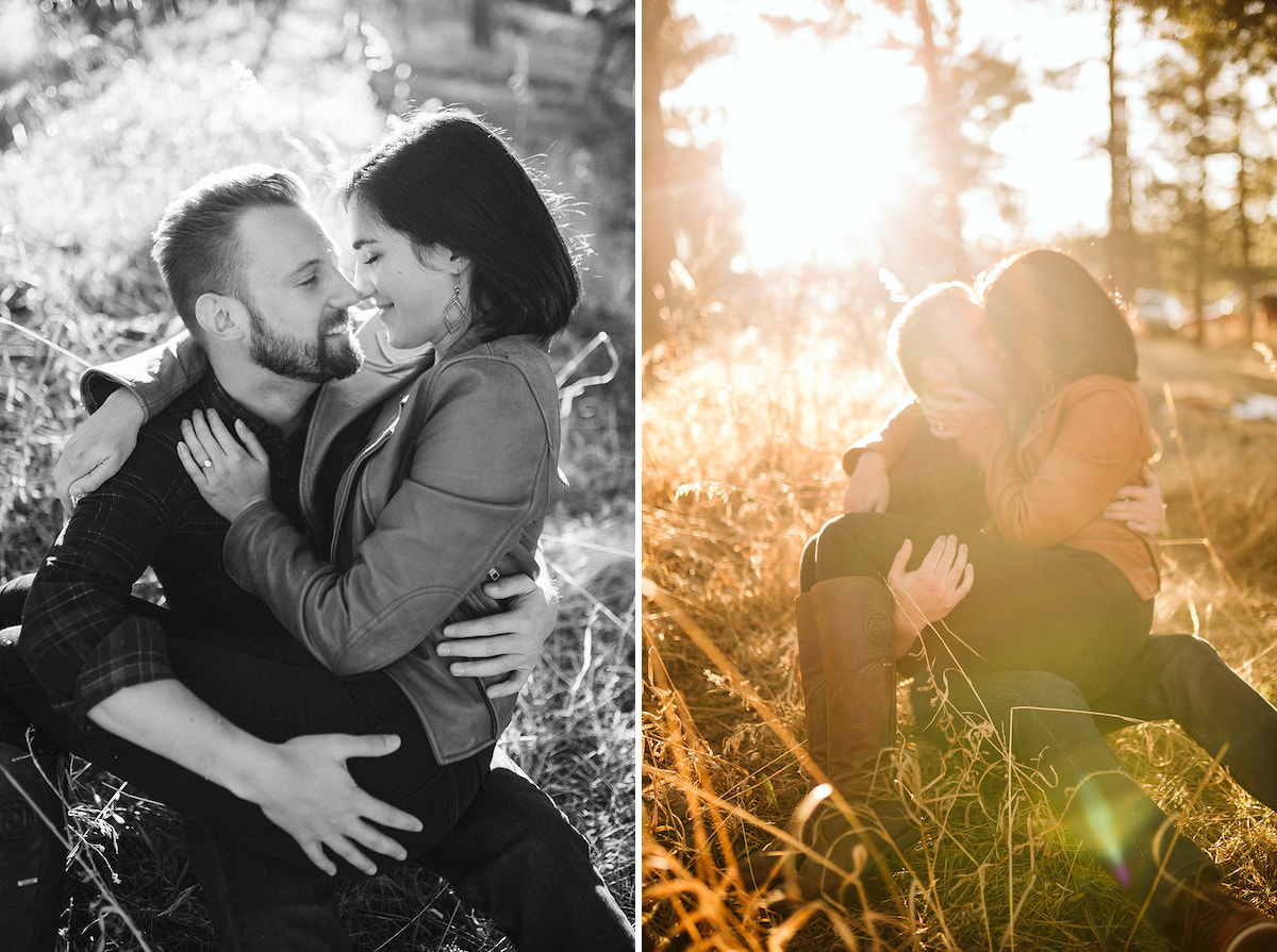 Man sits in tall golden grass with woman cuddling on his lap. She hugs one arm around his shoulder and leans toward him.