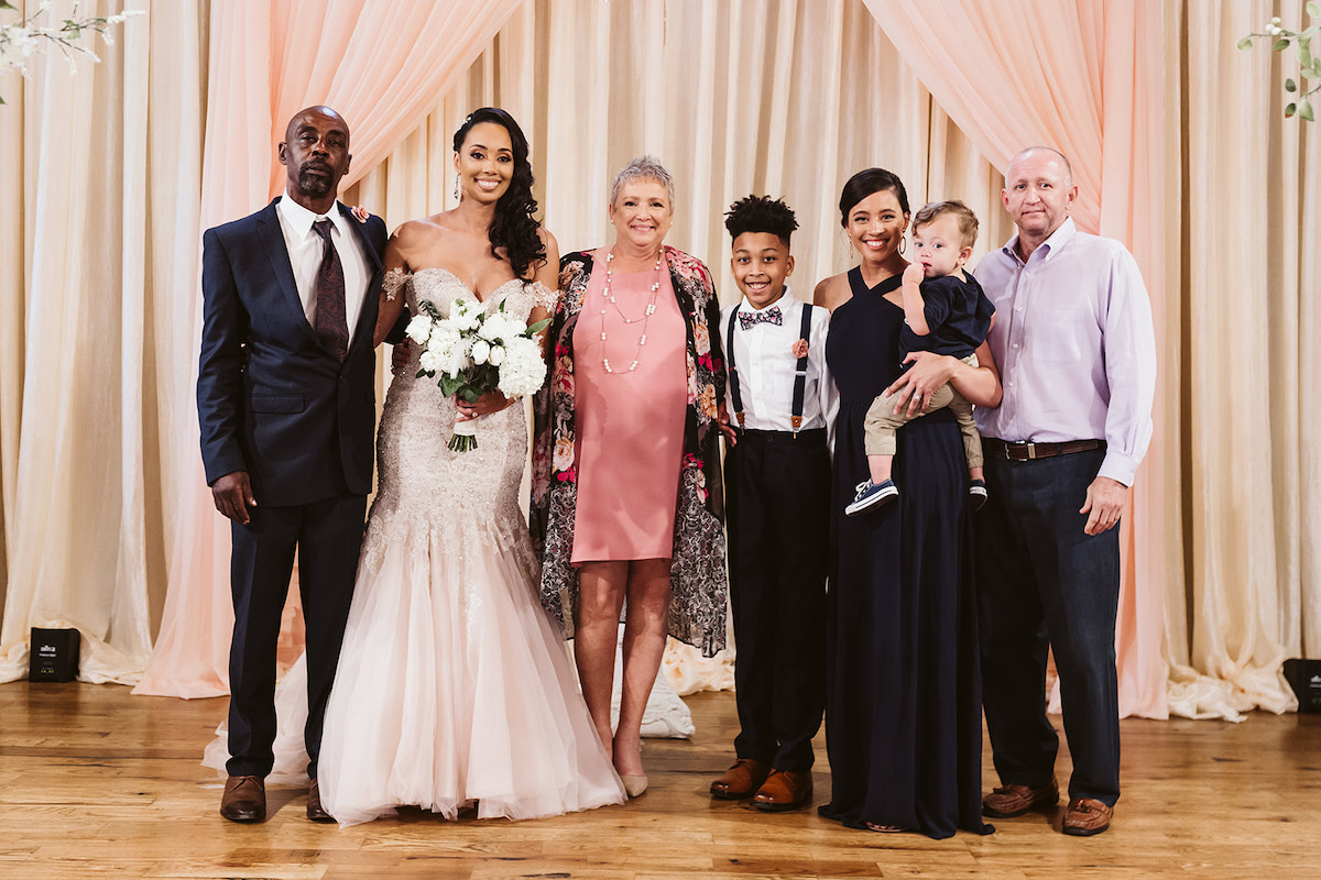 Bride stands with family members for a family photo