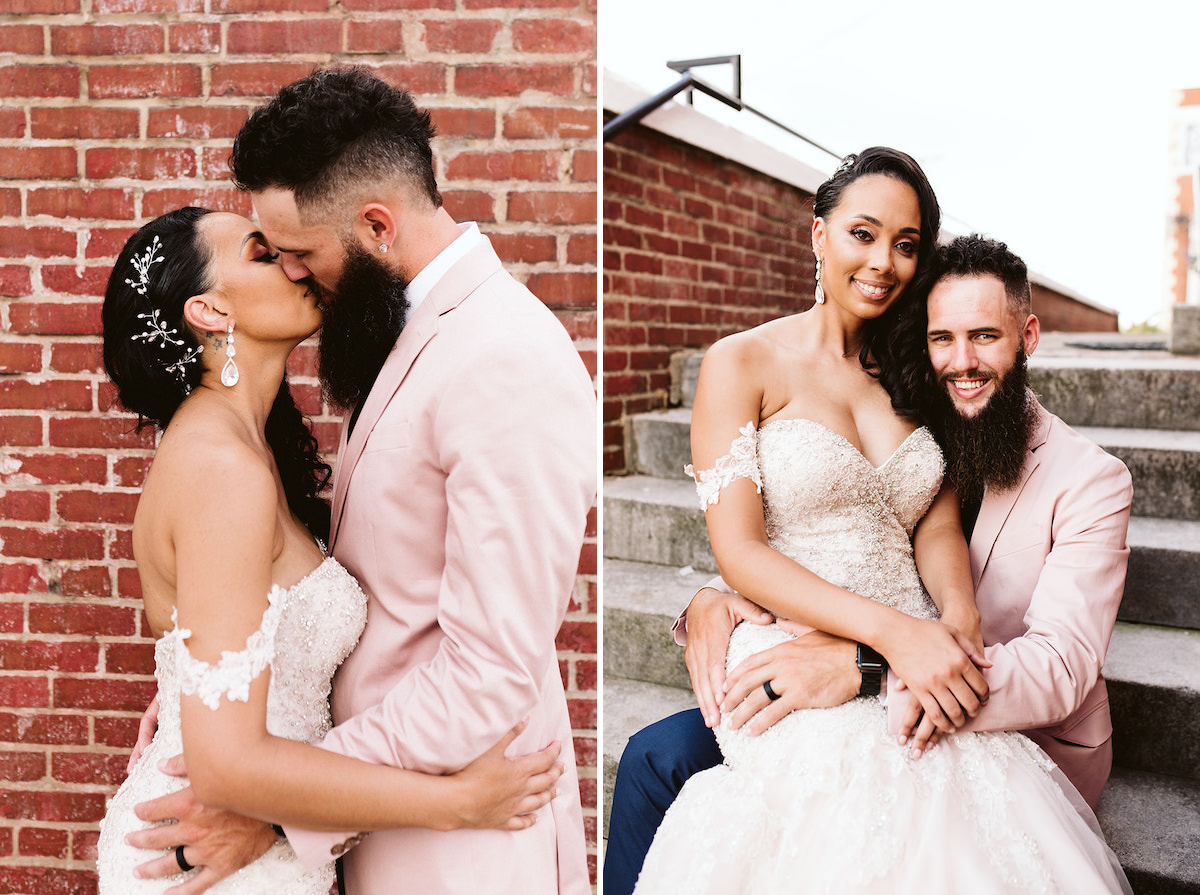 Groom sits on cement steps next to the brick exterior of The Church on Main in Chattanooga, TN. He holds bride and they laugh