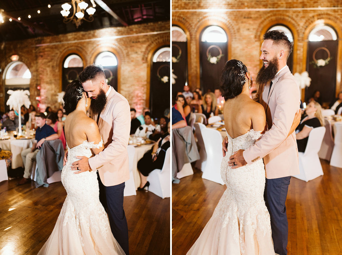 bride smiles at groom as they dance with the tall, arched windows the The Church on Main behind them.