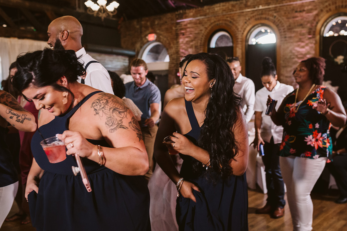 bridesmaids laugh and dance together