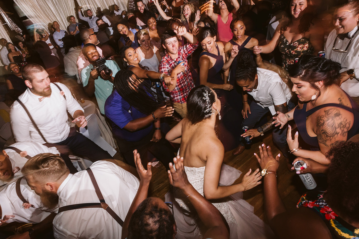 bride and groom dance with their friends during their wedding reception