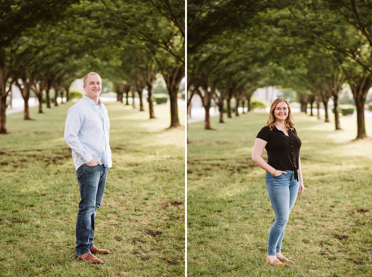 man and woman in jeans and casual tops stand below arched tree branches during their engagement photo session