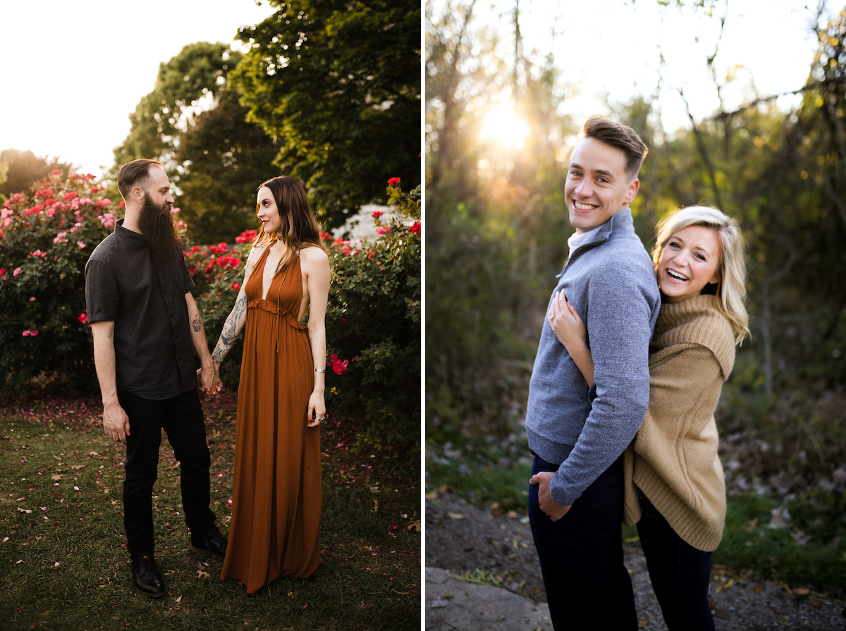 man in black short sleeve black shirt and black pants holds hands with a woman in amber halter dress next to flowering bushes