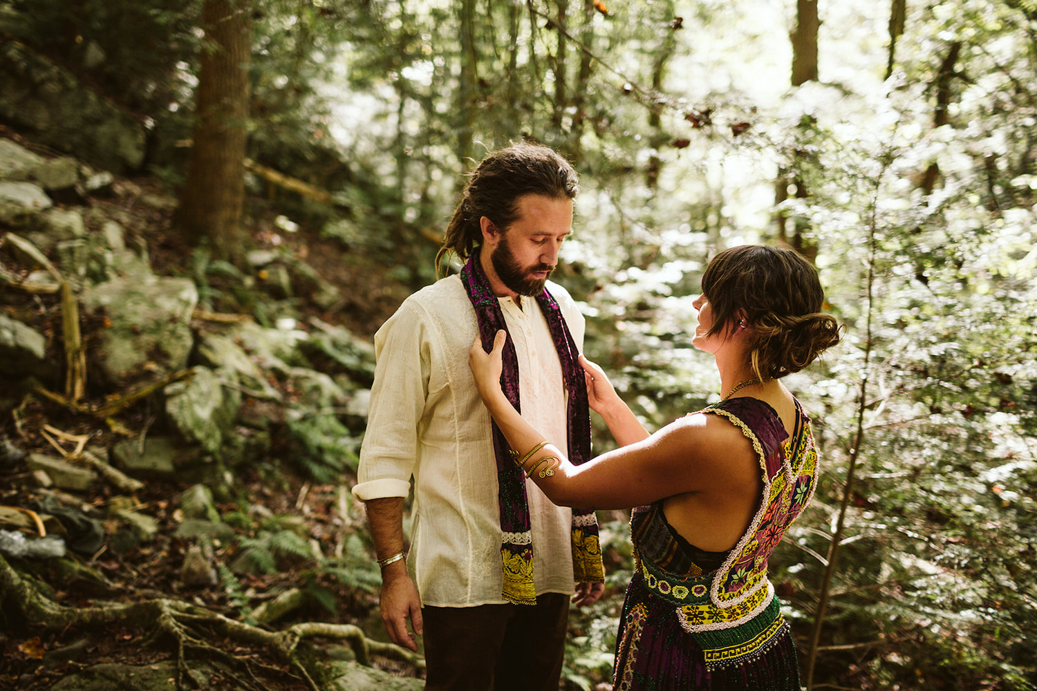 man and woman change into wedding attire in the woods near Foster Falls