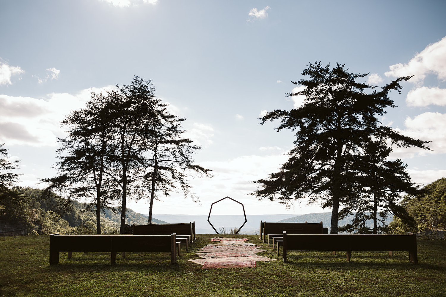 church pews and benches lead to simple heptagon wedding arch overlooking Hemlock Falls near Chattanooga, Tennessee