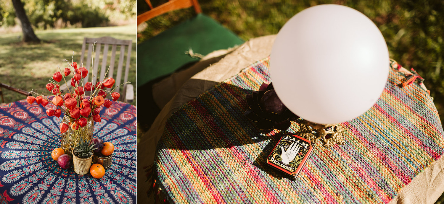 brightly colored table cloth on small table with palm reading book and crystal ball