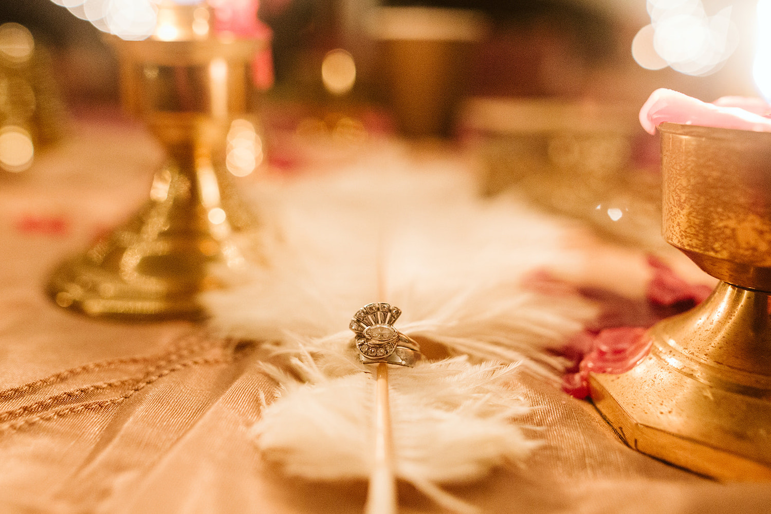 diamond wedding ring circled around a long white feather