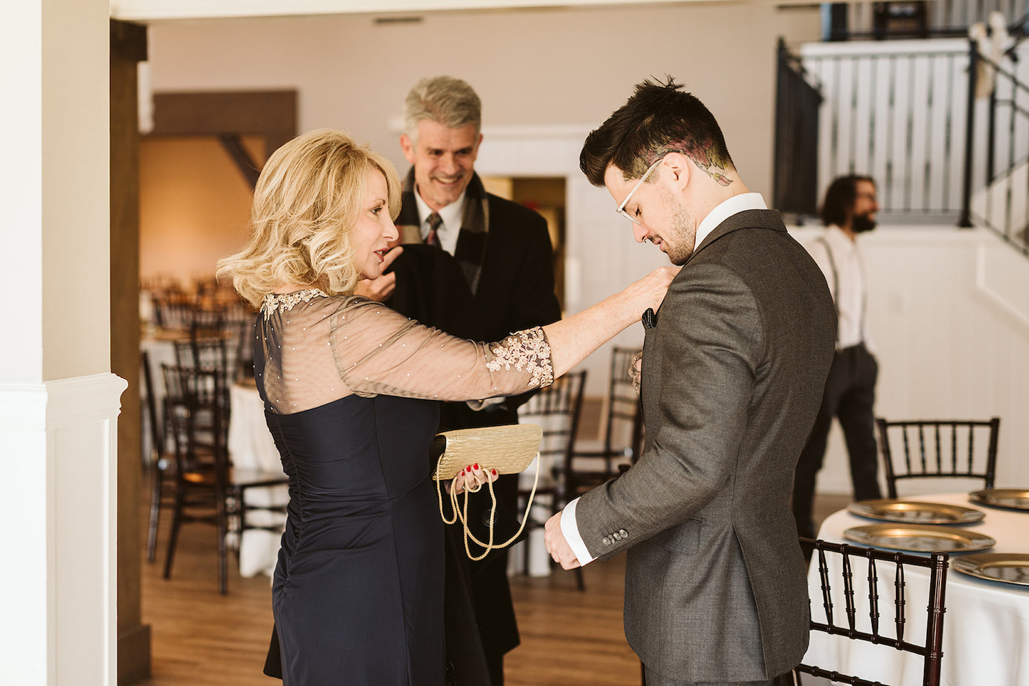 groom's mother adjusts his tie