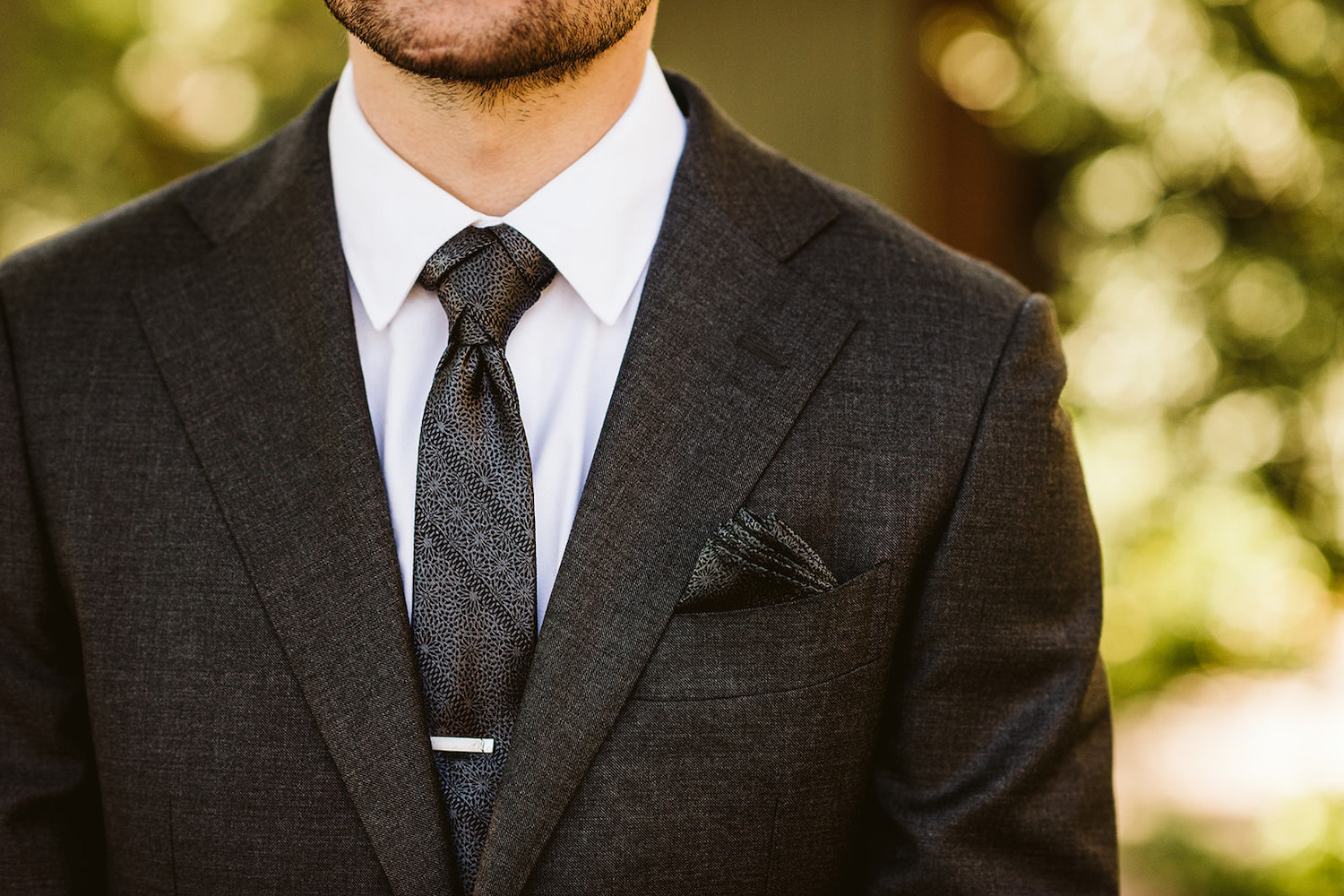 groom's dark suit and tie