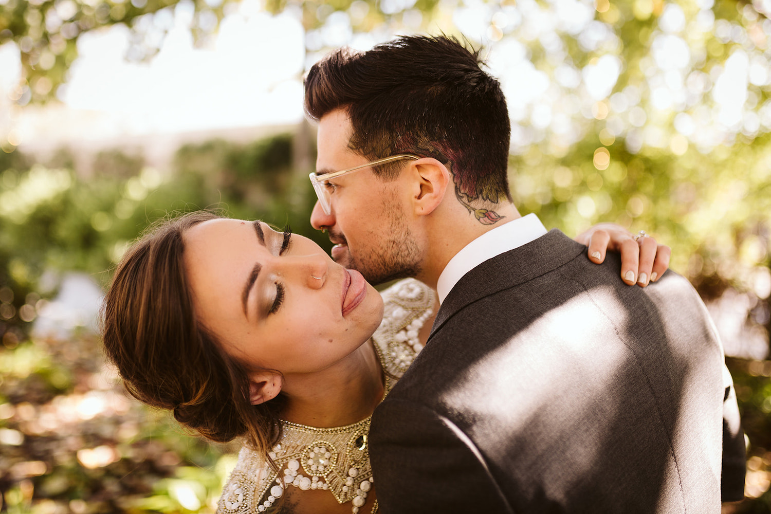 bride and groom hug and snuggle their faces together and make goofy faces